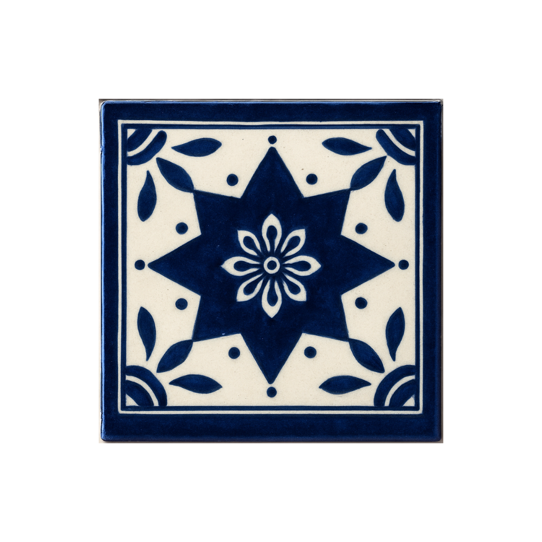 A hand-painted Talavera tile from Mexico, featuring intricate blue and white geometric patterns"